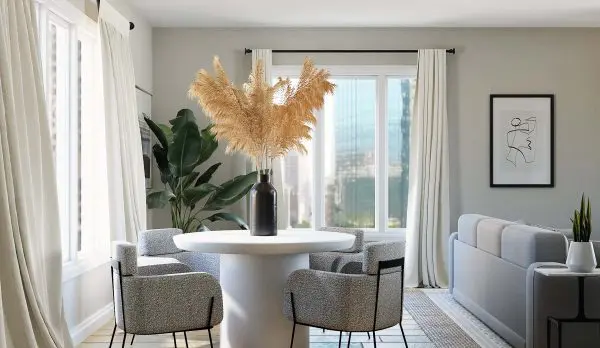 a stylish and neutral living room with hardwood floors and light shining through the windows