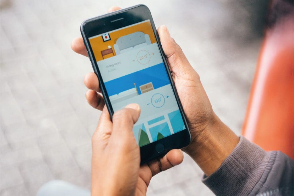 Someone on their phone using the Wunda Smart, smart home app
