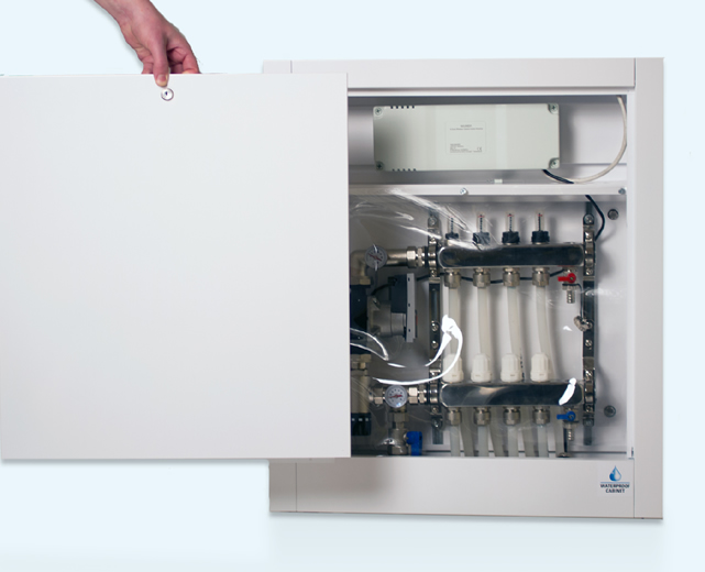 A waterproof cabinet containing pipework for an underfloor heating setup